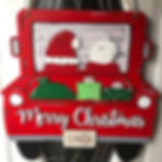 wooden doorhanger with Mr, and Mrs. Claus