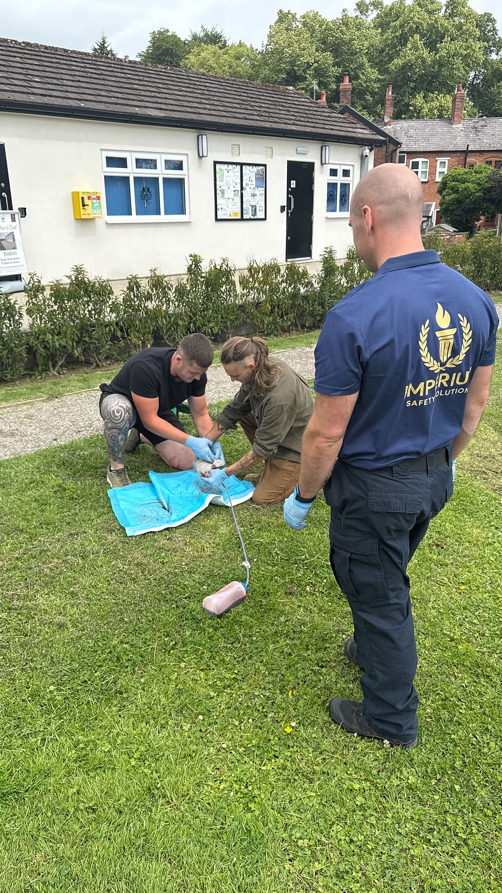 An Imperium Safety Solutions instructor supervising a scenario-based forestry first aid training session in an outdoor environment.