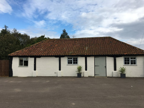 Wide exterior view of the Picture House accommodation on a rural Norfolk farm
