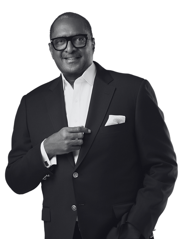 Mathew Knowles posing in a black suit