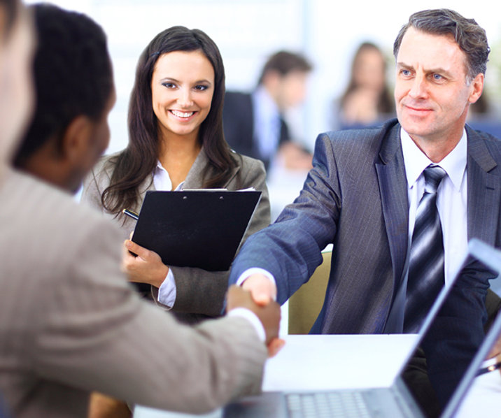 Group in suits shaking hands