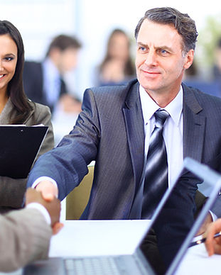 Group in suits shaking hands