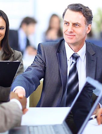 Group in suits shaking hands