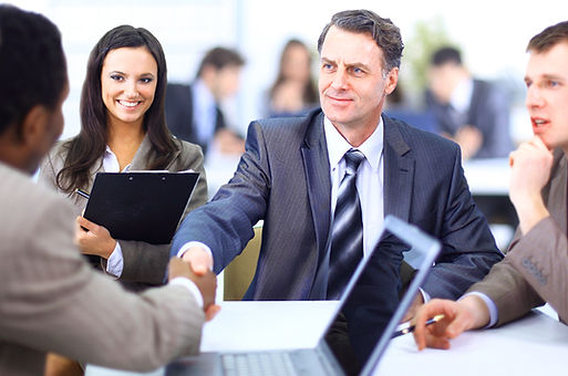 Group in suits shaking hands