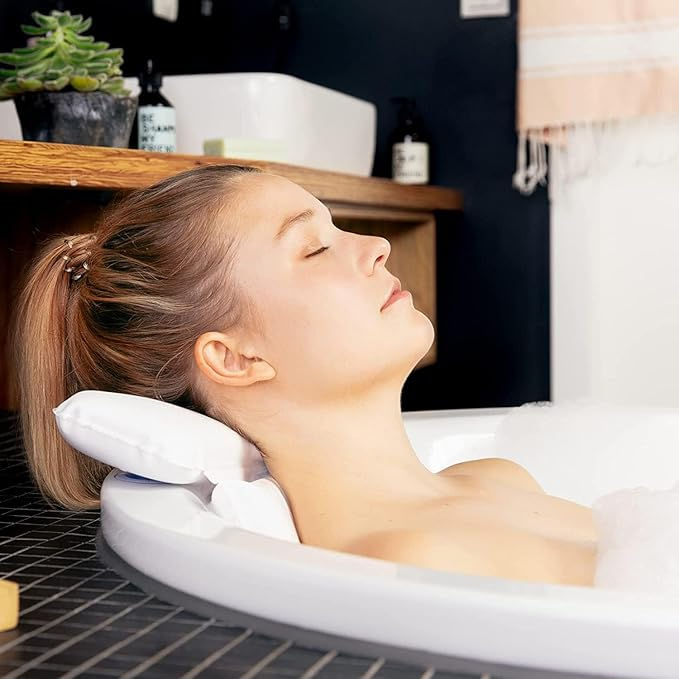 Close-up view of a soft bath pillow attached to a bathtub edge