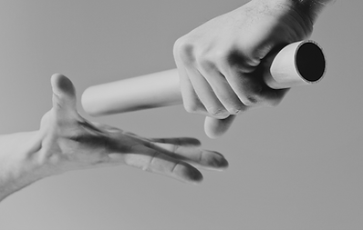 A photo of a baton being passed, Cadence is a partner in your marketing. We provide smooth, long and short-term partnerships
