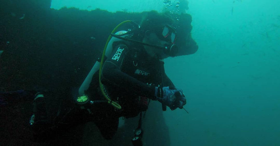 Scuba diver filming underwater