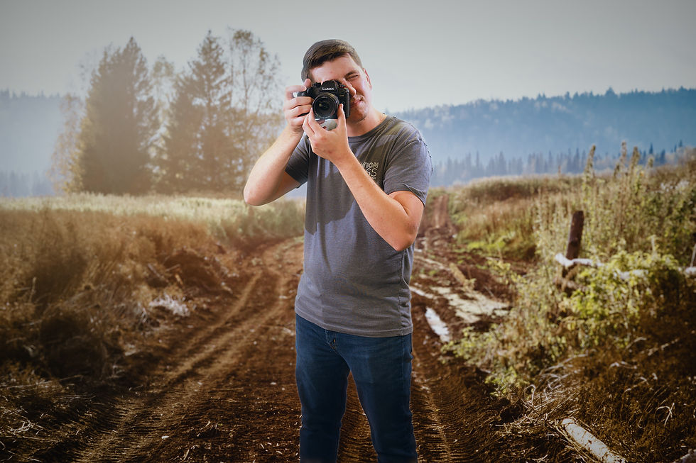 Caution Glass photographer pointing camera with a wooded trail in backgound