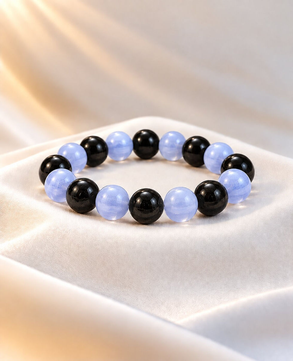 Number 8 numerology bracelet with black obsidian and blue lace agate worn on wrist by Sanskritii Sethi Global