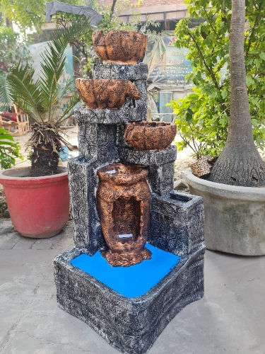 Outdoor decorative water fountain featuring a multi-tiered stone and ceramic design with cascading water bowls