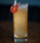 The Daisy de Machito cocktail by Brian Tasch and Brooke Toscano, a tall vibrant tropical cocktail on crushed ice garnished with a dehydrated pineapple flower.