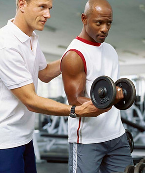 Trainer assisting gym workout