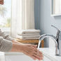 Woman enjoying the benefits of soft hot water in her home