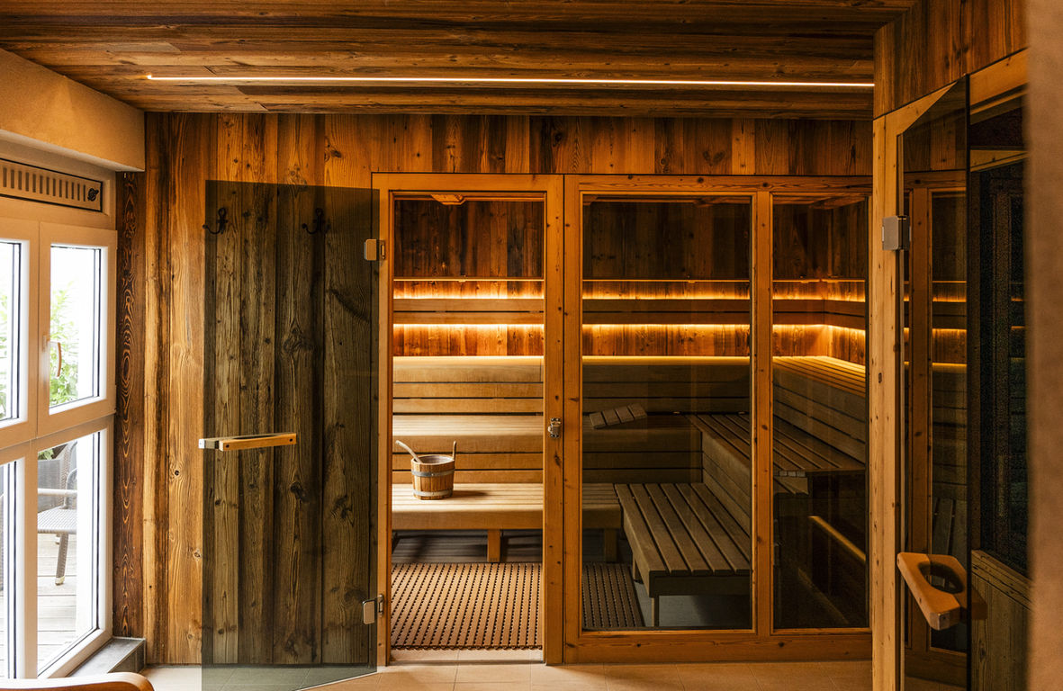 Wooden sauna with benches and lighting