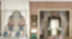 This is a close up view of the bed and dressing room area in the room above showing the similarities in color and appearance of the fabric on the headboard and the wallcovering behind the dressing table.