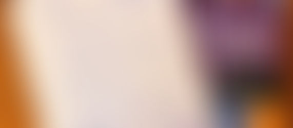 Notebook with handwritten notes on educational strategies for SIFE, next to a book titled "Boosting Achievement." Purple pen on top, wooden table.