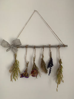 Branch wall hanging with dried flowers.