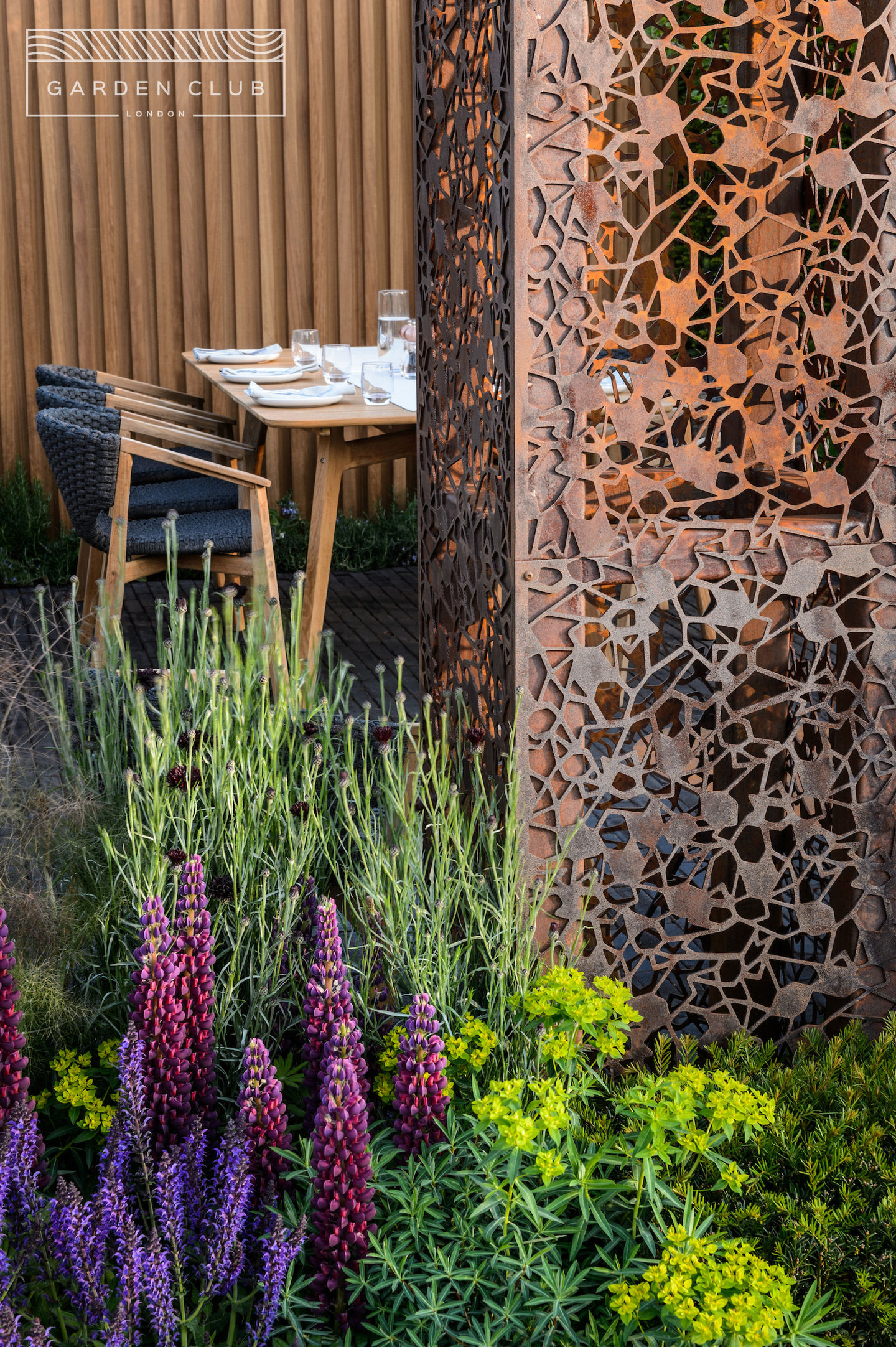 garden with sculptural steel and table set for food