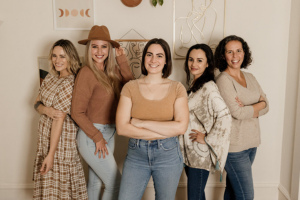 Group of five smiling business women standing together indoors, including Abby Valletta of Self Employed
Sisterhood — Easy Peasy VA client testimonial photo