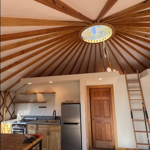Inside a 24' Lattice Wall Yurt complete build-out with kitchen