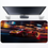 Thumbnail: Mouse pad showing a red and yellow race car speeding through a night-lit track with motion blur effects.