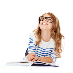 education and school concept - smiling little student girl with book and eyeglasses lying on the flo