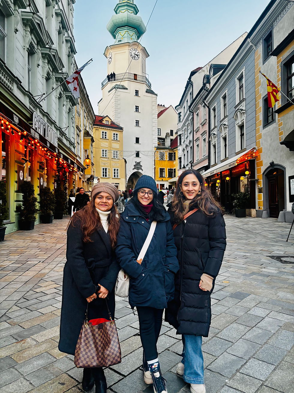 Three of us on our walking tour, standing in front of the Old Town Hall clock tower in Bratislava, right in the middle of it all.