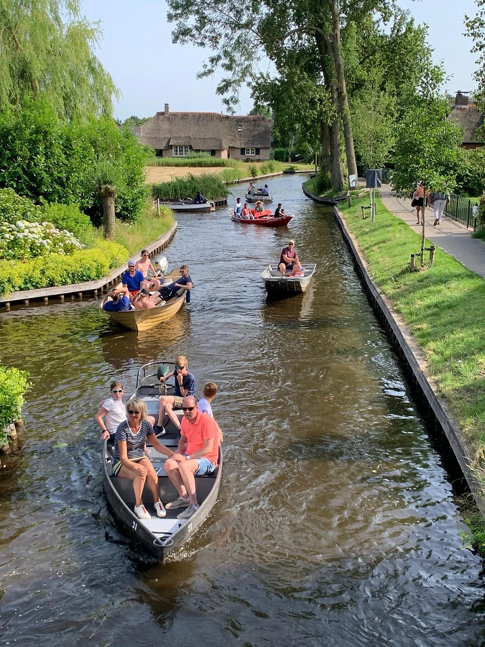 Visitors enjoy a leisurely boat ride along the picturesque canals of Giethoorn.