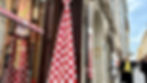 A large, checkered tie hanging outside a traditional tie shop on Radićeva Street in Zagreb's historic Upper Town.