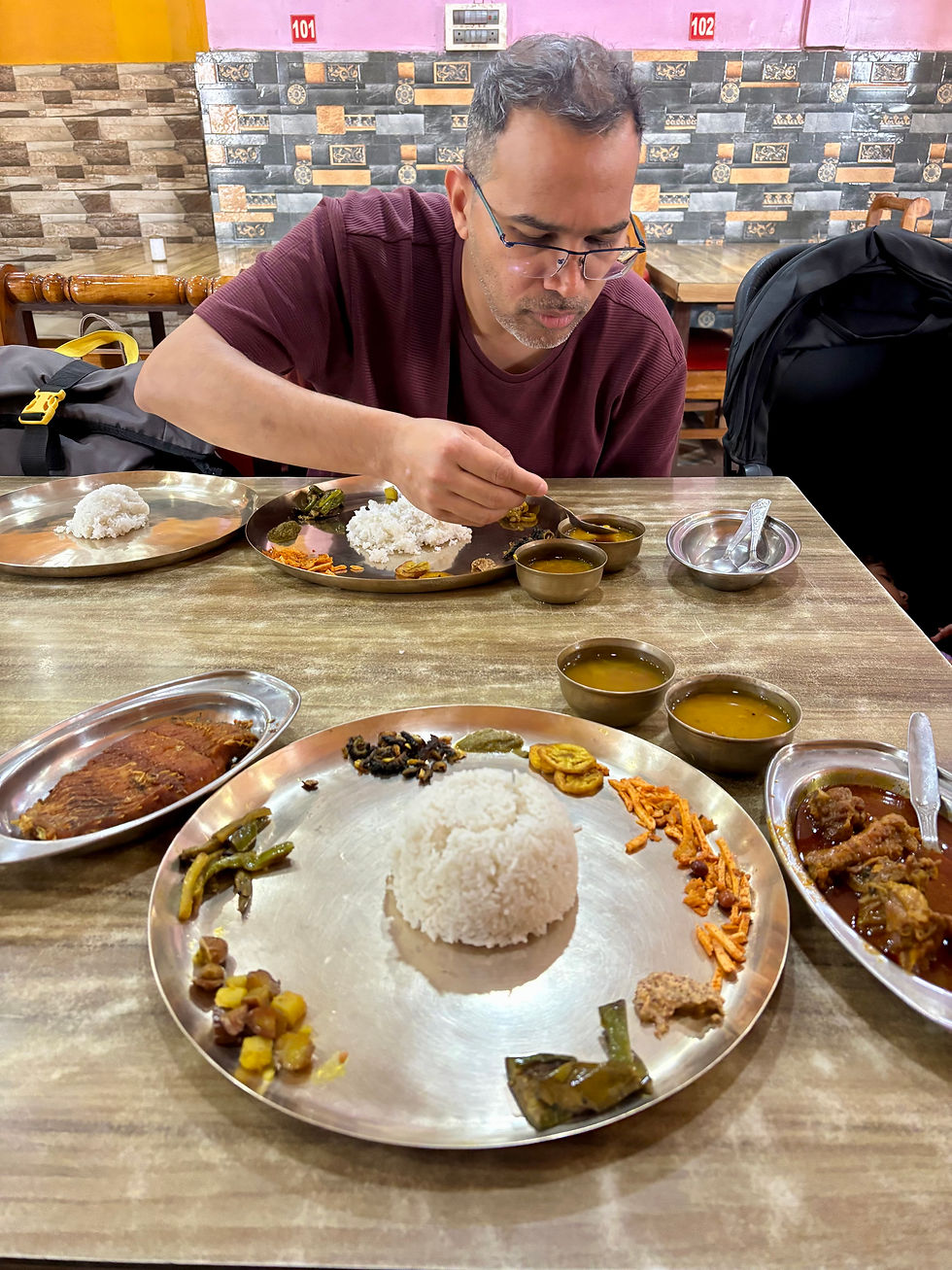 Sidd savoring his Assamese Bhojan one dish at a time