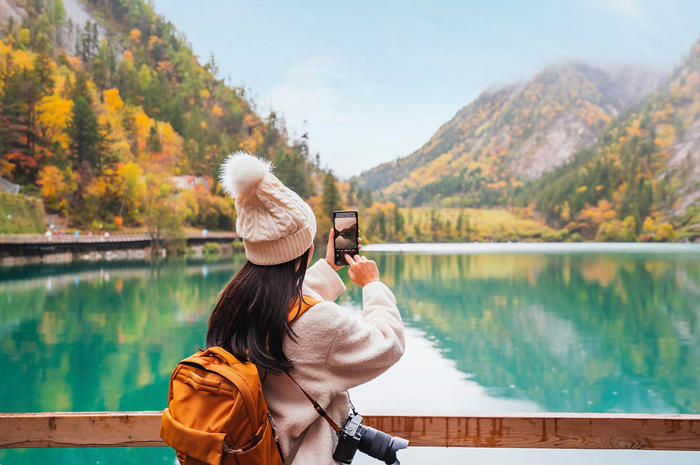 Girl taking picture of a fall landscape