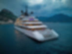 Eye-level view of a luxury river cruise ship sailing along a calm river surrounded by lush greenery