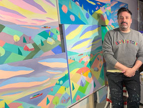 Artist Pierre Bouchard with his artworks in his studio
