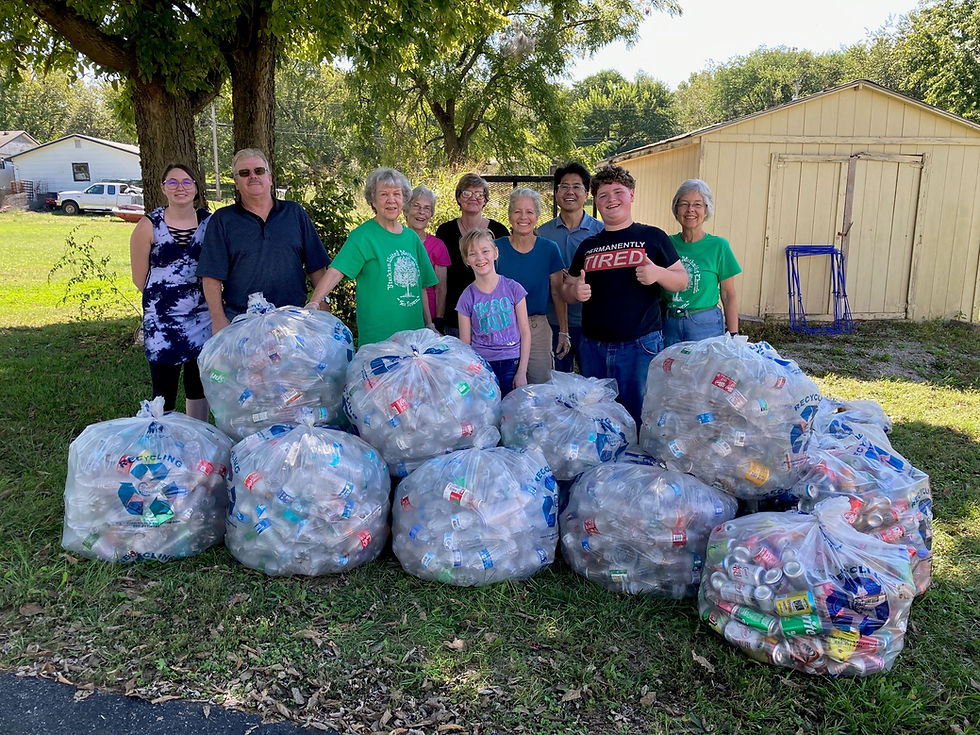 Sorting and de-capping volunteers show off 12 bags of de-capped plastic water bottles, two bags of aluminum cans, and 10 gallons of glass bottles: Emma Clemons, Mike and Janice Dunne, Dodie Parkhurst, Michelle Moniz, Hadassa Griffin, Diedre Senecal, Pastor Daniel Na, Yehoshua Griffin, and Cheryl Marcum. --Contributed by Cheryl Y. Marcum