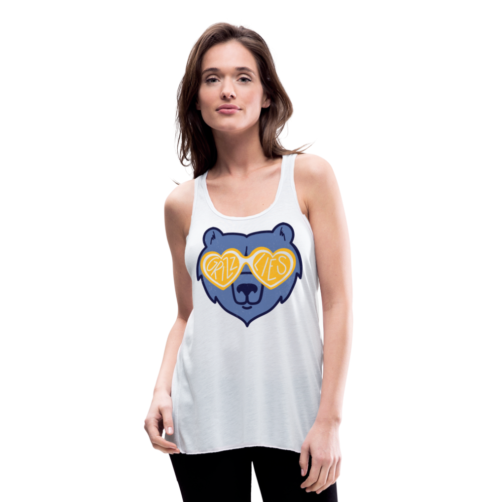 A white woman wearing a white Bella Canvas Flowy Racerback tank top with a distressed light blue Grizz Glasses design on the