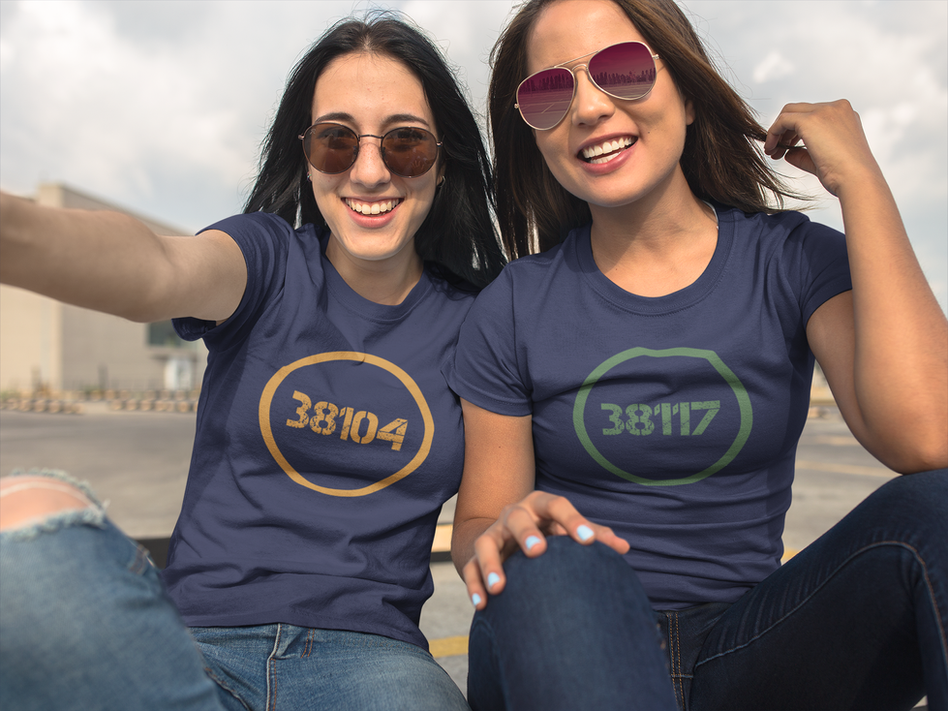 Photo of two beautiful girls wearing unisex round neck navy blue Bella + Canvas tees with the 38104 and 38117 Memphis Tennessee zip codes while outdoors