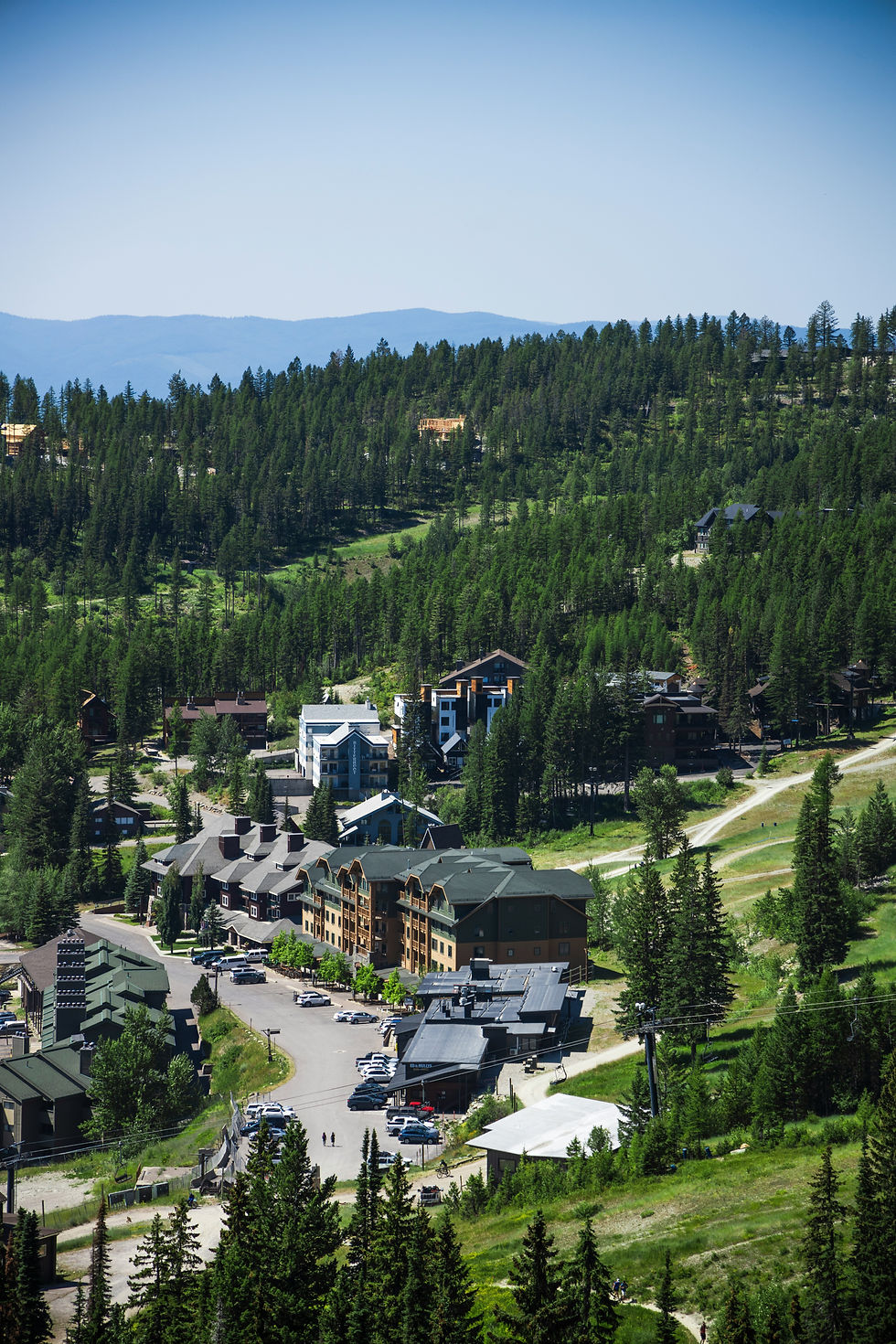 Whitefish Montana mountain landscape with forest and cabins, family travel destination in Montana