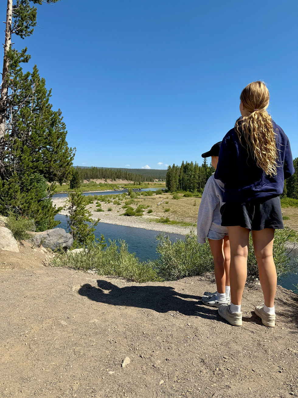 Family overlooking a river in Lamar Valley near Yellowstone National Park from Red Lodge Montana
