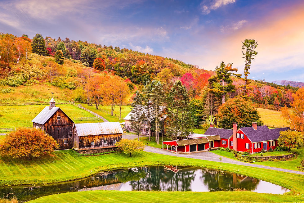 Red barn surrounded by fall foliage in the Woodstock, Vermont countryside