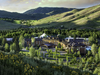 Aerial view of Sun Valley Idaho resort nestled in forested mountain valley in summer