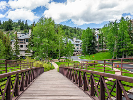 Wooden bridge leading into Beaver Creek Village Colorado — luxury family ski resort with ski-in ski-out access and mountain views