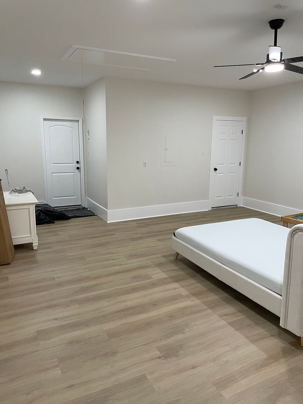 Finished garage conversion into living space with luxury vinyl plank flooring and recessed lighting by Barger Home Improvements in Covington Louisiana