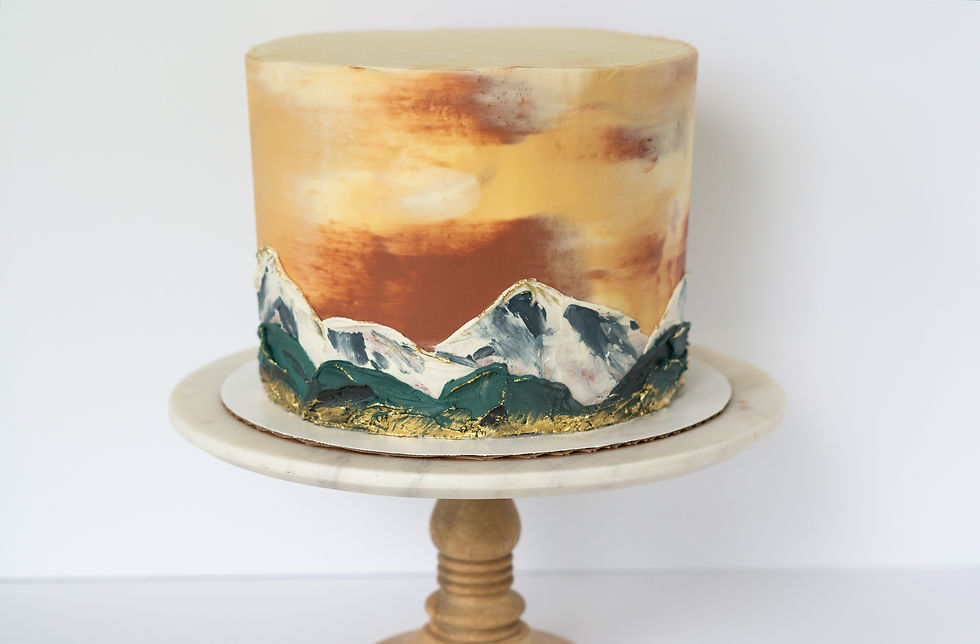 mountain wedding cake, sunset motif background with palette knife painted mountain scene in deep green and white with painted gold accents