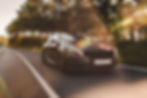 front-view-black-luxury-sedan-road.jpg