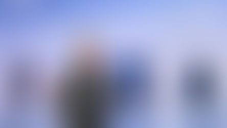 Samsung CEO TM Roh in a suit stands on stage, gesturing, with Samsung electronic appliances and "Your Companion to AI Living" text in the background.