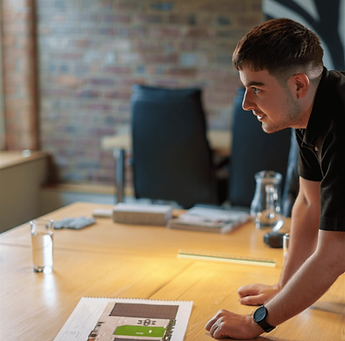 Professional reviewing a document on an office desk