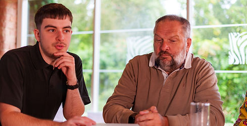 Two garden design experts discussing a project outdoors.