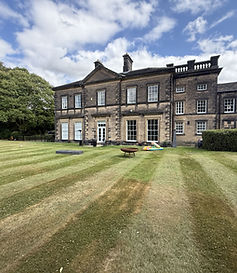 Large manor house at The Estate Garden with striped lawn