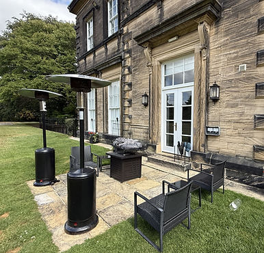 Stone patio with outdoor heaters at The Estate Garden.