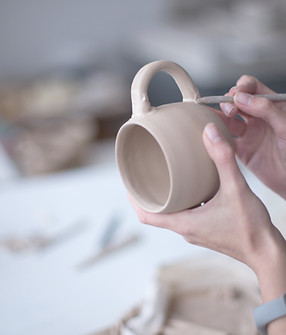 Female Potter Making Mug
